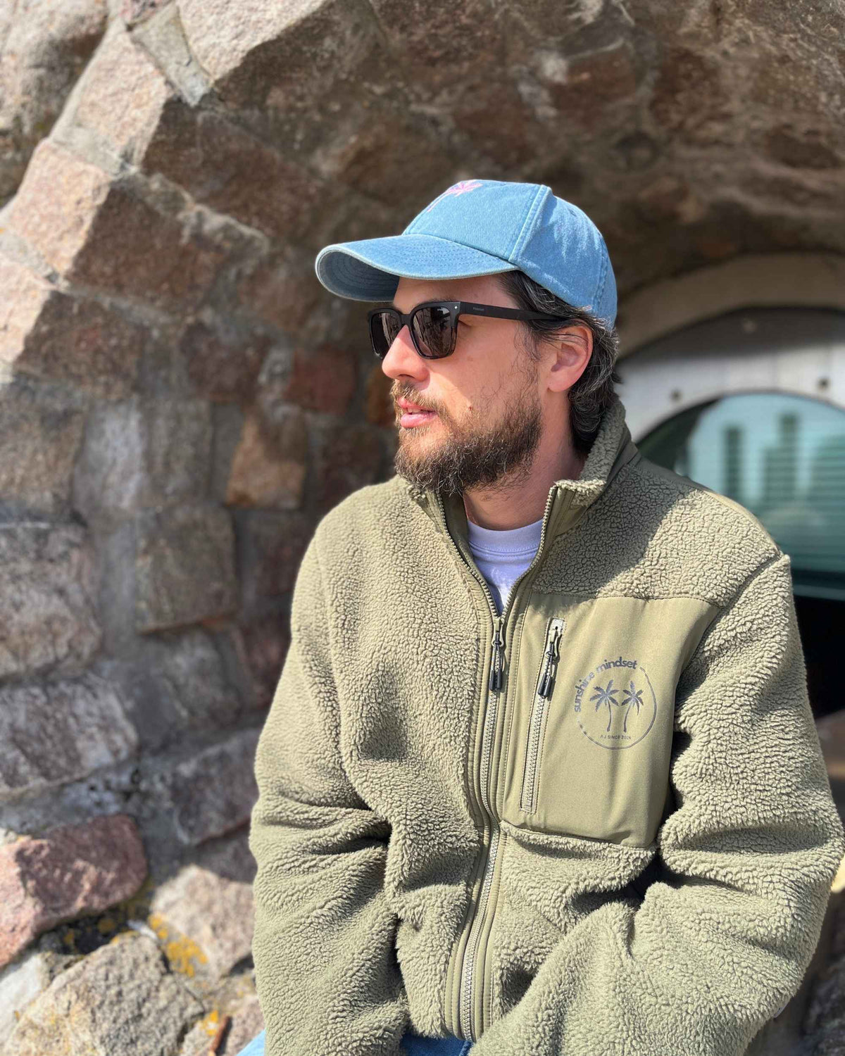 Khakifarbene Unisex-Teddyjacke mit schwarzem sunshine mindset Logo auf der Brust
